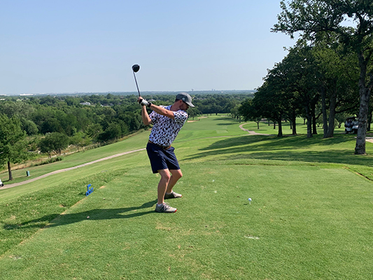 golfer teeing off