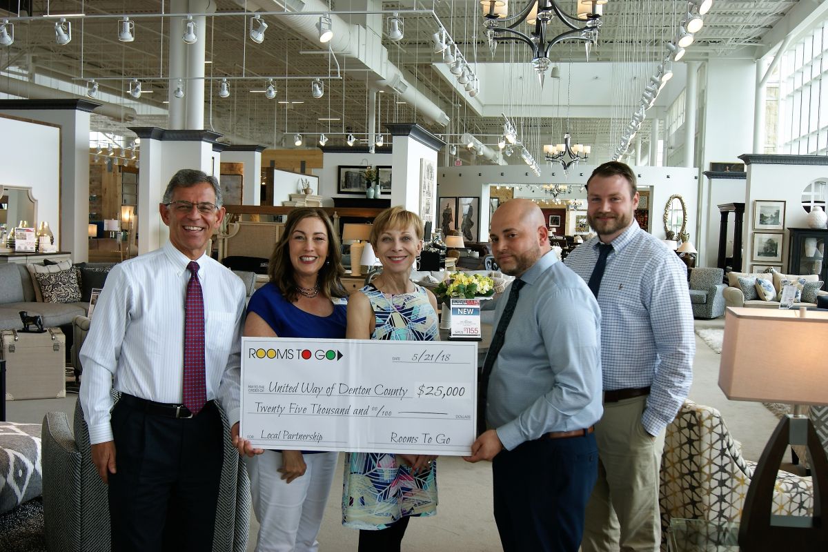 Gary Henderson, Micah Pazoureck & Jo Ann Ballantine accept $25,000 check from Rooms To Go store manager Jeremiah Gonzalez and assistant manager Ryan Hobbs