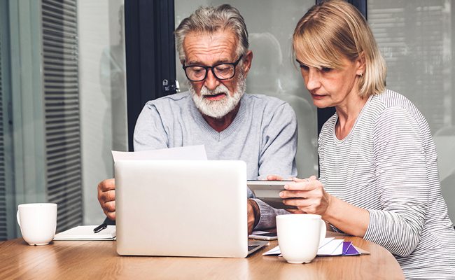 Man and woman working on a laptop