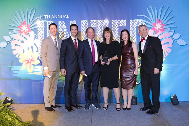 Bob and Terry Widmer accept Humanitarian Award along with their children