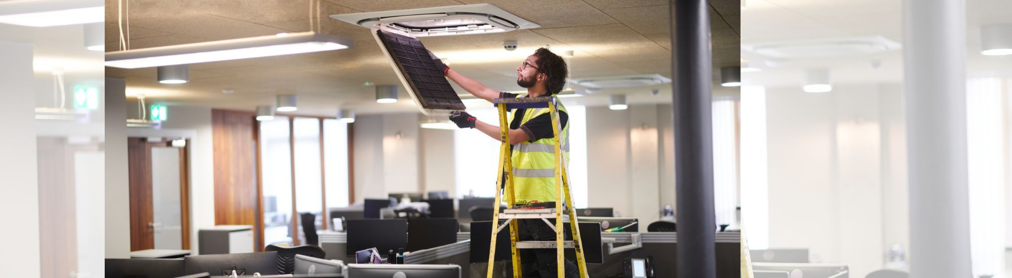 Worker fixing ceiling light