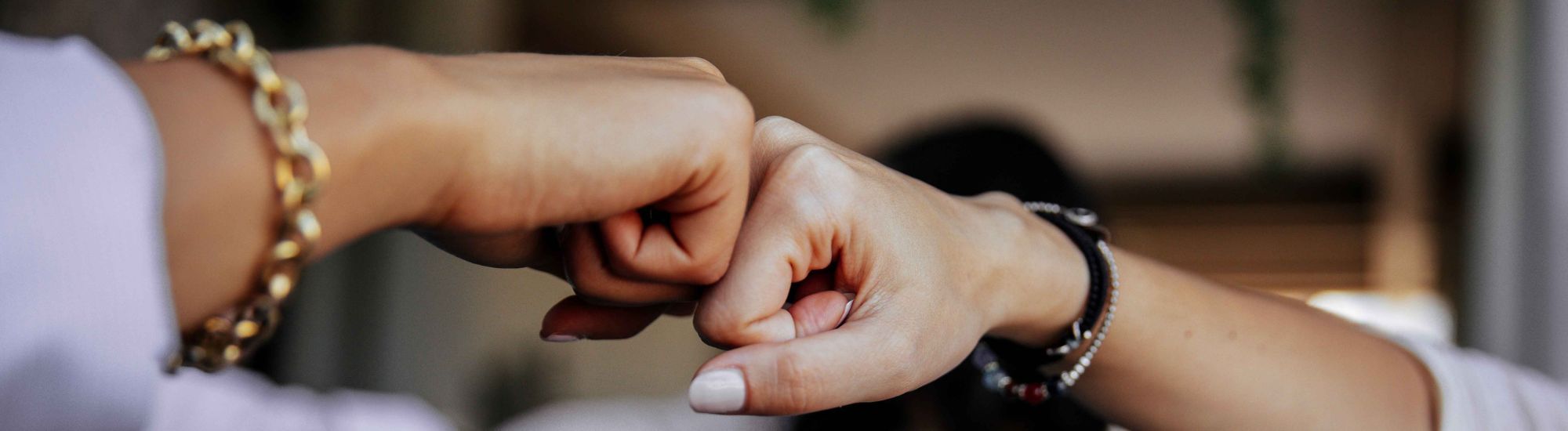 two hands fist-bumping