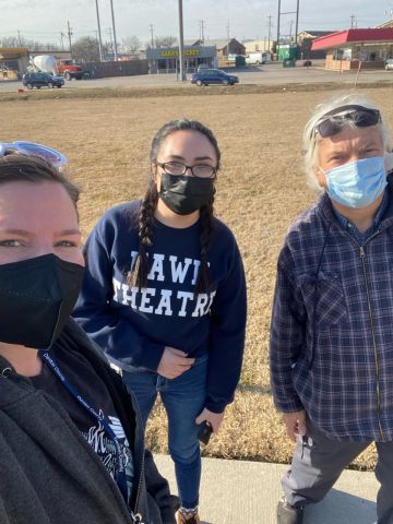 3 individuals, wearing masks, outside taking a picture together on PIT day