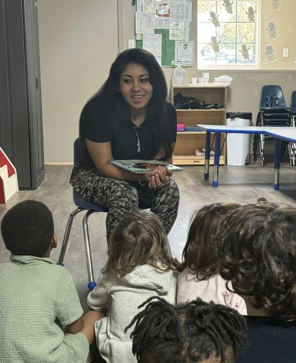 Chef Gabby reads to children at DreamSpark Academy